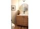 Stylish powder room features a natural wood vanity, vessel sink, round mirror, and contemporary fixtures at 2193 Kildare Nw Way, Kennesaw, GA 30152