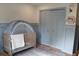 Cozy Bedroom featuring a crib, closet, and charming wall decor at 2193 Kildare Nw Way, Kennesaw, GA 30152