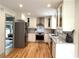 Open concept kitchen with stainless steel appliances and ample counter space at 2193 Kildare Nw Way, Kennesaw, GA 30152