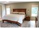 Comfortable main bedroom with a wooden bed frame, neutral colors, and plenty of natural light at 2193 Kildare Nw Way, Kennesaw, GA 30152