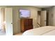 Stylish main bedroom displaying a painting, wood dresser, and doors to the bathroom and hallway at 2193 Kildare Nw Way, Kennesaw, GA 30152