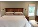 Comfortable main bedroom with neutral colors, a wooden bed frame, and plenty of natural light at 2193 Kildare Nw Way, Kennesaw, GA 30152