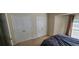Bedroom with two closet doors and light streaming through the window at 3263 Mill Springs Circle Northeast Cir, Buford, GA 30519