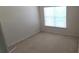 This bedroom has neutral colored walls and carpeting with a large window at 3263 Mill Springs Circle Northeast Cir, Buford, GA 30519