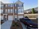Charming brick townhome with blue shutters and a well-maintained front yard and a truck parked in the driveway at 3263 Mill Springs Circle Northeast Cir, Buford, GA 30519