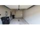 Spacious garage interior, ready for parking and storage, with garbage cans and ladder at 3263 Mill Springs Circle Northeast Cir, Buford, GA 30519