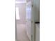 Hallway with a view into a carpeted room, showcasing natural light from the window at 3263 Mill Springs Circle Northeast Cir, Buford, GA 30519