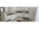 Well-lit kitchen with white cabinets, a breakfast bar, and modern appliances at 3263 Mill Springs Circle Northeast Cir, Buford, GA 30519