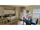 Functional kitchen with a dining area, white cabinets, and access to a deck, perfect for Gathering meals at 3263 Mill Springs Circle Northeast Cir, Buford, GA 30519