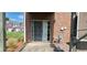 Cozy brick patio with sliding glass door access and view of well-maintained lawn and neighboring townhomes at 3263 Mill Springs Circle Northeast Cir, Buford, GA 30519