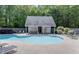 Community pool with lounge chairs and bath house surrounded by lush greenery at 3263 Mill Springs Circle Northeast Cir, Buford, GA 30519