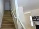 Carpeted stairway with white railing leading to the upper level at 3263 Mill Springs Circle Northeast Cir, Buford, GA 30519