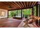 Enjoy the hot tub, overhead fan, string lights, and rocking chairs on this elevated outdoor deck at 3275 Lord N Lady Ln, Alpharetta, GA 30022