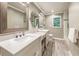 Well-designed bathroom with a modern vanity, wood-look flooring, and ample natural light at 3275 Lord N Lady Ln, Alpharetta, GA 30022