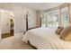 Cozy bedroom with large windows, plantation shutters, and a comfortable bed at 3275 Lord N Lady Ln, Alpharetta, GA 30022