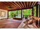 Relaxing covered deck with hot tub, lounge chairs, ceiling fan and string lights at 3275 Lord N Lady Ln, Alpharetta, GA 30022