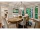 Inviting dining room featuring large windows, wood floors, and a stylish light fixture at 3275 Lord N Lady Ln, Alpharetta, GA 30022