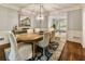 Bright dining room with a large wooden table, stylish seating, and views of the living room at 3275 Lord N Lady Ln, Alpharetta, GA 30022