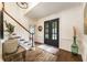 Elegant foyer with hardwood floors, staircase, and stylish decor at 3275 Lord N Lady Ln, Alpharetta, GA 30022