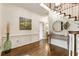 Bright foyer with hardwood floors, staircase, and elegant wainscoting at 3275 Lord N Lady Ln, Alpharetta, GA 30022