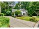 Beautiful two-story home with a manicured front yard and a long driveway at 3275 Lord N Lady Ln, Alpharetta, GA 30022