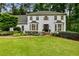 Charming two-story traditional home with manicured lawn, lush landscaping, and stately front entrance at 3275 Lord N Lady Ln, Alpharetta, GA 30022