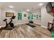 Bright home gym features wood floors, light gray walls, and a wall of mirrors at 3275 Lord N Lady Ln, Alpharetta, GA 30022