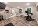 Home gym with wood-look floors, fitness equipment, and windows overlooking greenery at 3275 Lord N Lady Ln, Alpharetta, GA 30022