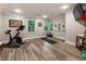 Bright home gym features wood-look floors, ample natural light, and modern fitness equipment at 3275 Lord N Lady Ln, Alpharetta, GA 30022