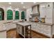 Spacious kitchen features white cabinets, stainless appliances, stone countertops, island and hardwood floors at 3275 Lord N Lady Ln, Alpharetta, GA 30022