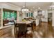 Open concept kitchen featuring stone countertops, eat-in island, hardwood floors, open dining and a screened-in porch at 3275 Lord N Lady Ln, Alpharetta, GA 30022