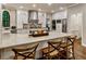 Bright kitchen featuring white cabinetry, stainless appliances, a large island, and bar stool seating at 3275 Lord N Lady Ln, Alpharetta, GA 30022
