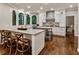 Open kitchen with white cabinetry, stainless steel appliances, stone countertops and hardwood flooring at 3275 Lord N Lady Ln, Alpharetta, GA 30022