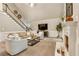 Cozy living room with a fireplace, staircase, and comfortable seating arrangement at 3275 Lord N Lady Ln, Alpharetta, GA 30022