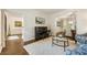 Bright living room featuring a piano, hardwood floors, an area rug, and comfortable seating at 3275 Lord N Lady Ln, Alpharetta, GA 30022