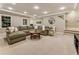 A spacious basement living room with a comfortable sectional and a large, round coffee table at 3275 Lord N Lady Ln, Alpharetta, GA 30022