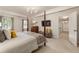 Relaxing main bedroom featuring a four-poster bed, plush carpet, and a TV at 3275 Lord N Lady Ln, Alpharetta, GA 30022