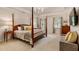 Bright main bedroom featuring a four-poster bed, plush carpet, and ample natural light at 3275 Lord N Lady Ln, Alpharetta, GA 30022
