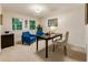 Well-lit office with three windows, neutral carpet, two blue chairs, and a black table at 3275 Lord N Lady Ln, Alpharetta, GA 30022