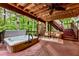 Cozy outdoor hot tub on a wood deck with ceiling fan and string lights at 3275 Lord N Lady Ln, Alpharetta, GA 30022