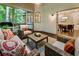 Cozy screened-in porch with wicker furniture, natural light, and scenic views to the outside at 3275 Lord N Lady Ln, Alpharetta, GA 30022