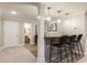 Finished basement wet bar area with bar seating, lighting, and an open doorway at 3275 Lord N Lady Ln, Alpharetta, GA 30022