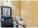 Bathroom with yellow walls featuring a decorative sink and toilet at 4515 Ambassador Way, Cumming, GA 30040