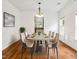 Dining room featuring hardwood floors, wainscoting, and modern chandelier at 4515 Ambassador Way, Cumming, GA 30040