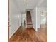 Inviting foyer with hardwood floors and staircase leading to upper level and dining room at 4515 Ambassador Way, Cumming, GA 30040
