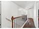 Hallway with wood floors, white walls, and wrought iron railing overlooking the stairs at 4515 Ambassador Way, Cumming, GA 30040