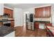 Spacious kitchen features stainless steel appliances, dark countertops, and wood cabinets at 4515 Ambassador Way, Cumming, GA 30040