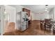 A spacious kitchen with a stainless steel refrigerator, dining table, and adjoining room at 4515 Ambassador Way, Cumming, GA 30040