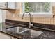 Close-up of stainless steel kitchen sink with modern faucet and granite countertops at 4515 Ambassador Way, Cumming, GA 30040