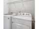 Functional laundry room with modern washer and dryer, plus practical shelving for storage at 4515 Ambassador Way, Cumming, GA 30040